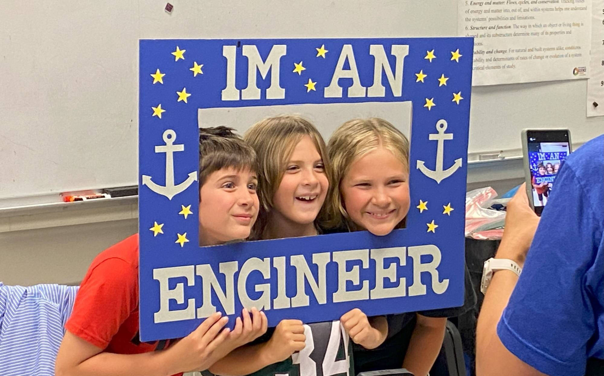 Children with a frame that reads "I'm An Engineer"